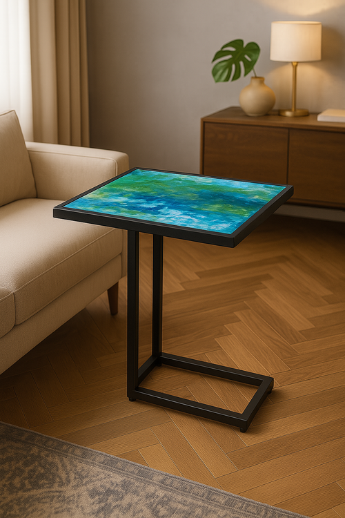 Blue and green epoxy side table with minimalist black C-leg base in a cozy living room.