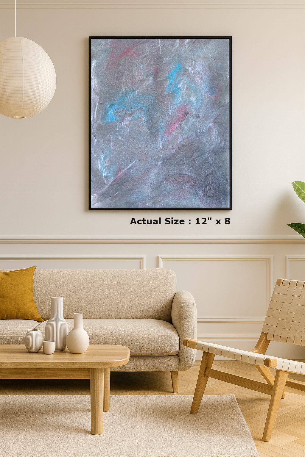 Abstract grey and blue resin wall art with soft textured swirls and shimmer, framed on a neutral wall.