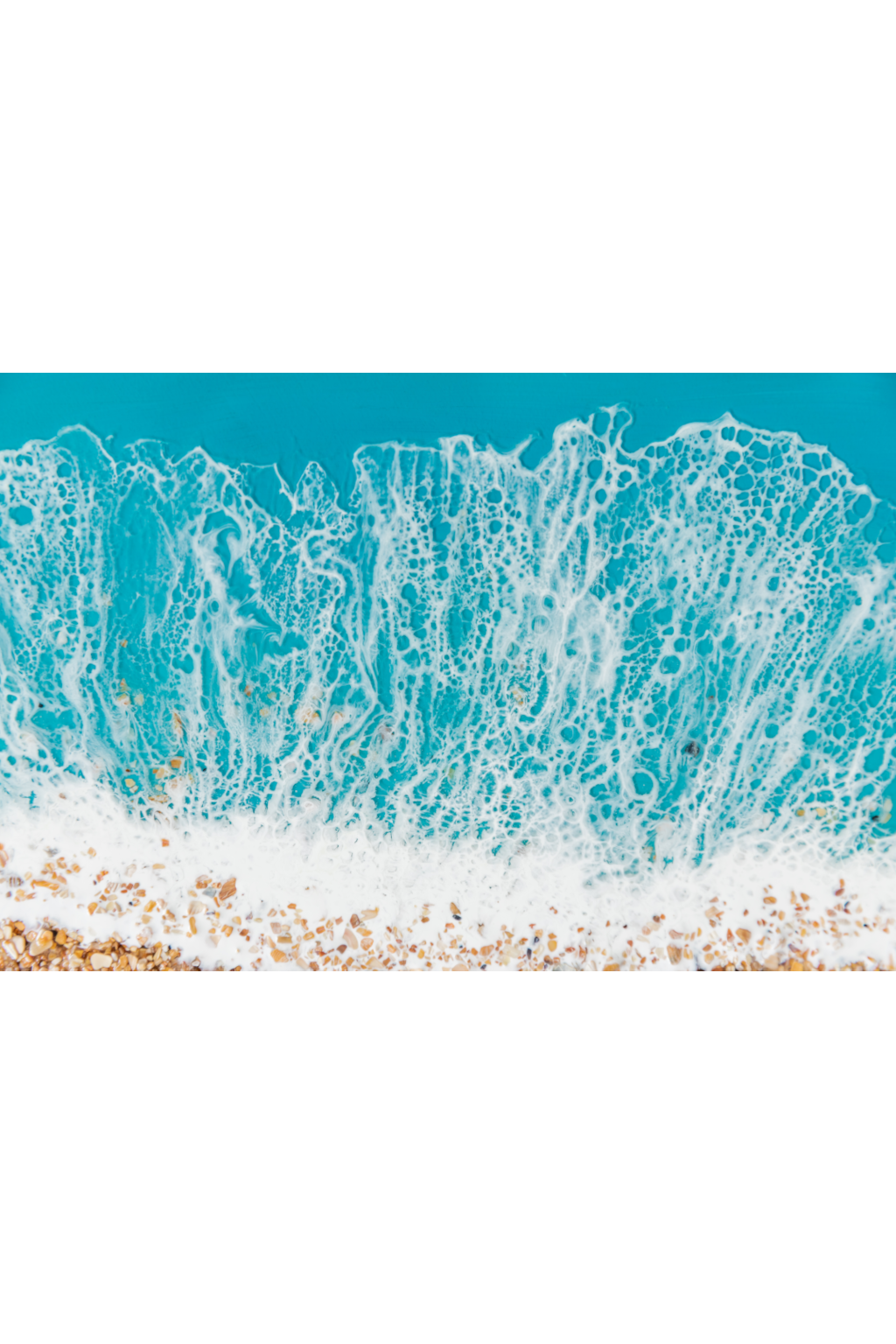 Close-up of ocean waves crashing onto a beach with turquoise water and white foam.